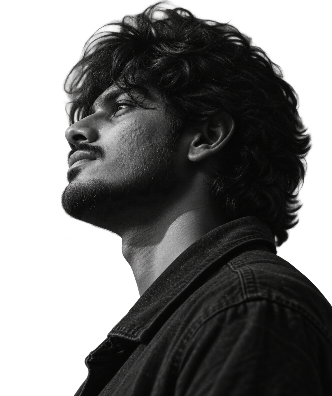 Black and white profile of Sashi Kadiri looking upward, his curly hair lit from the side